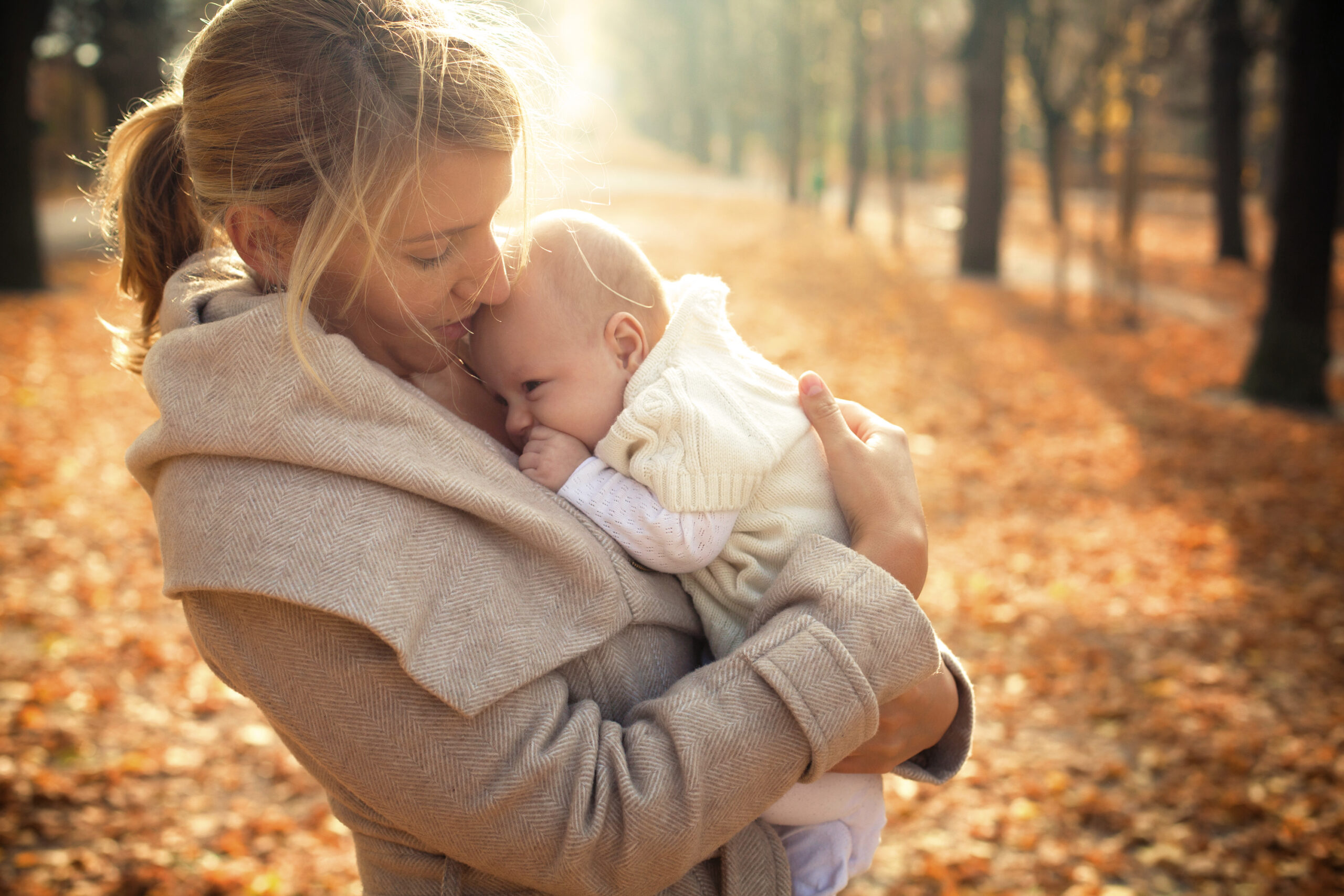Parent holding a baby outdoors