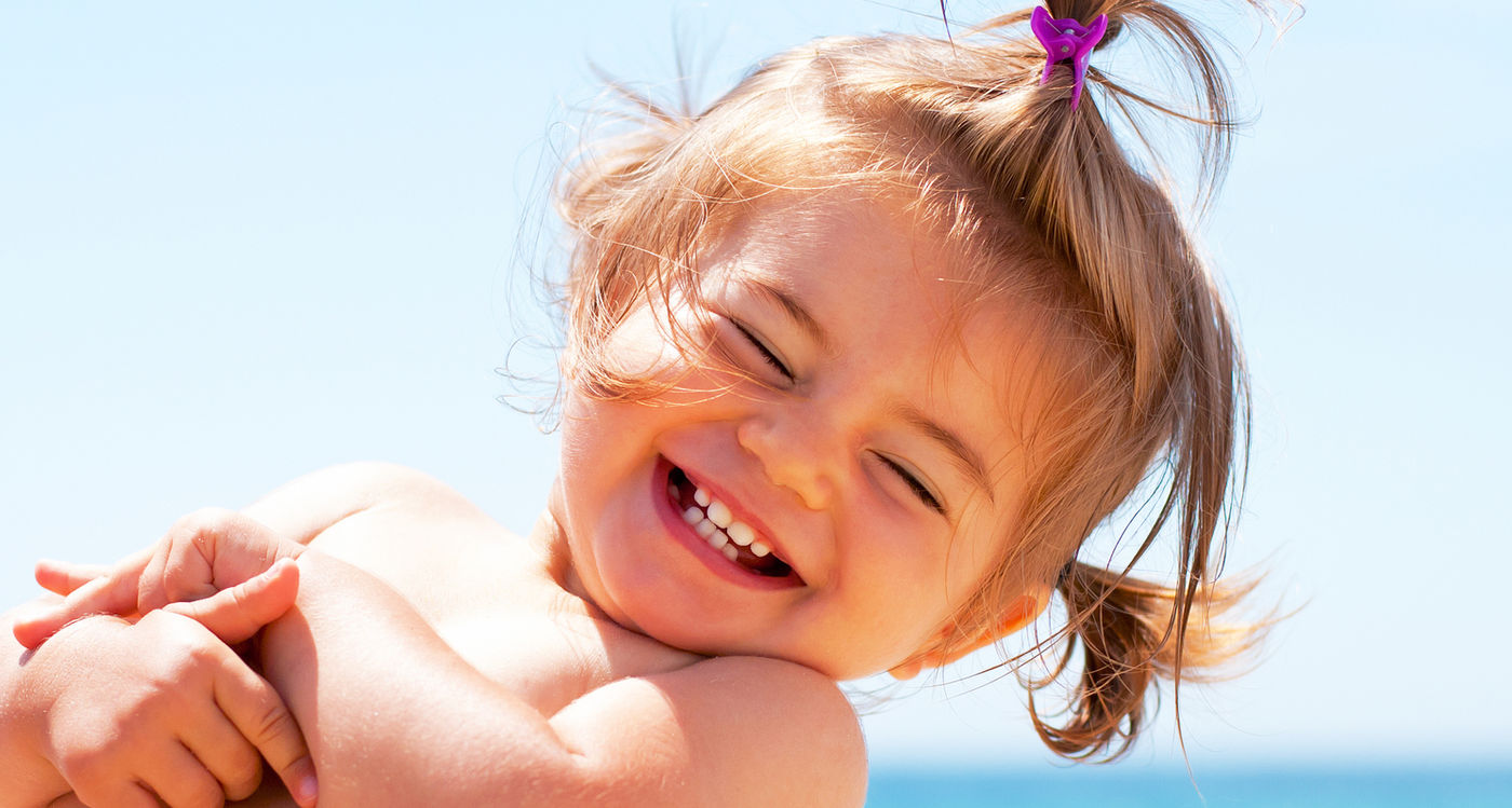 Child smiling outdoors