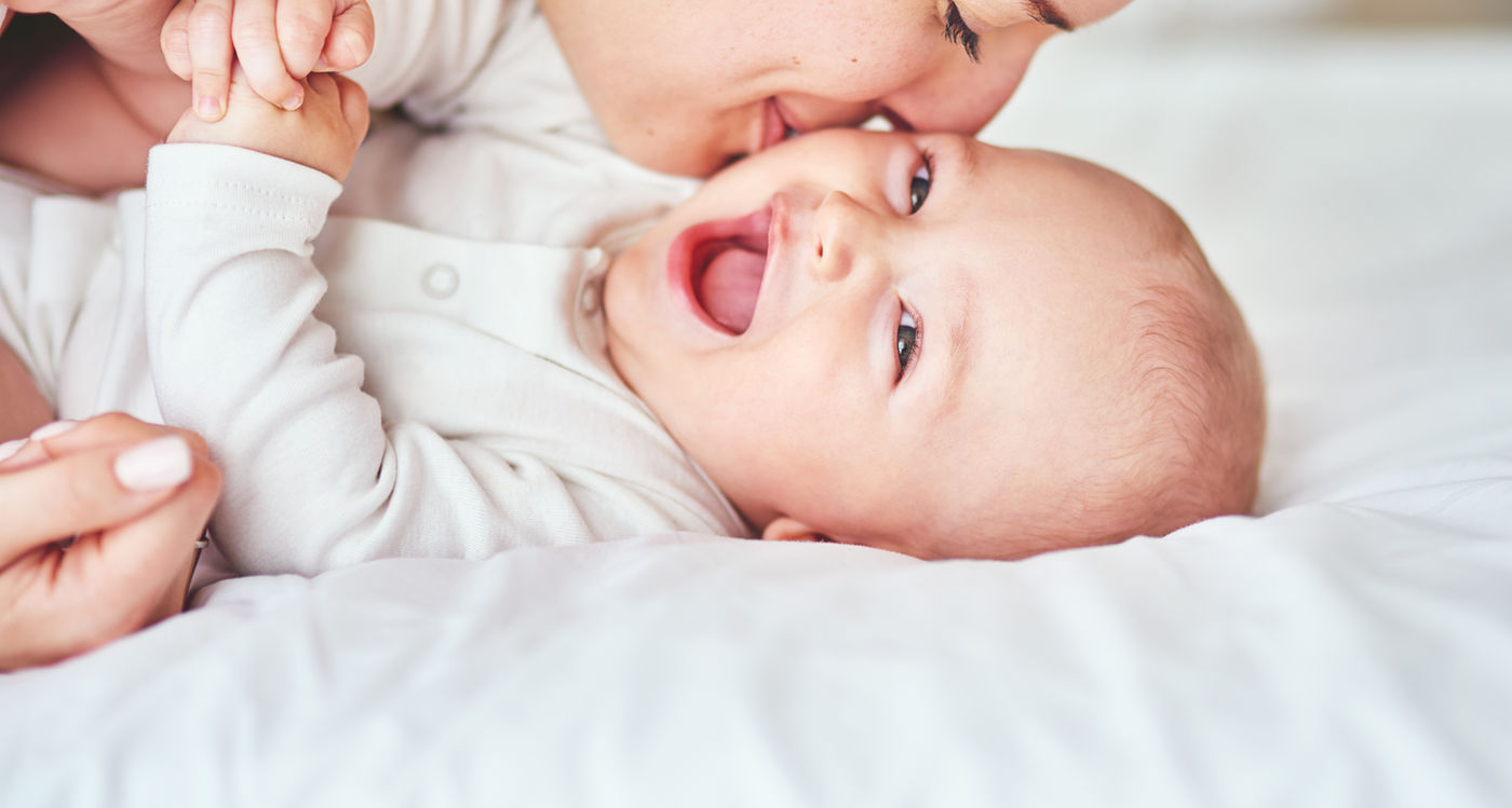Baby learning to walk with a parent