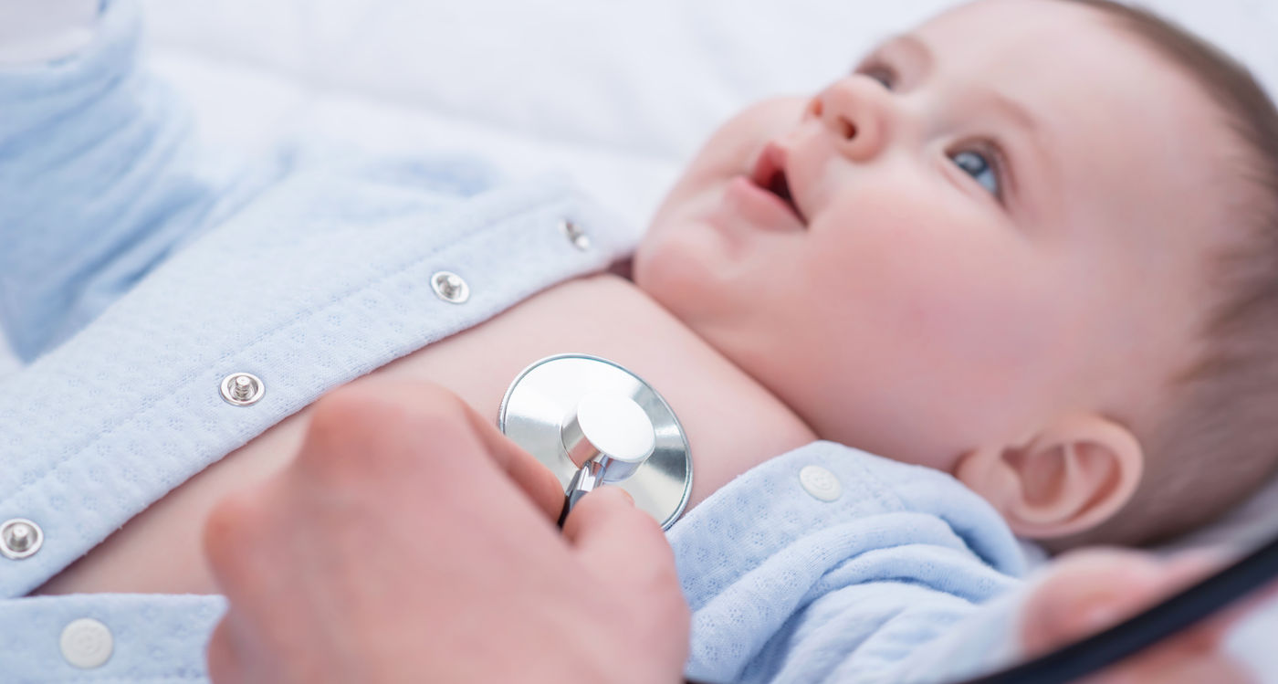 Pediatrician examining an infant